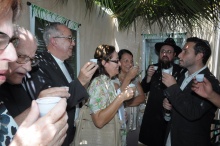 Os participantes da celebração brindam dentro da Sucá. Fotógrafo Antônio Albuquerque. Acervo do Núcleo de Memória.