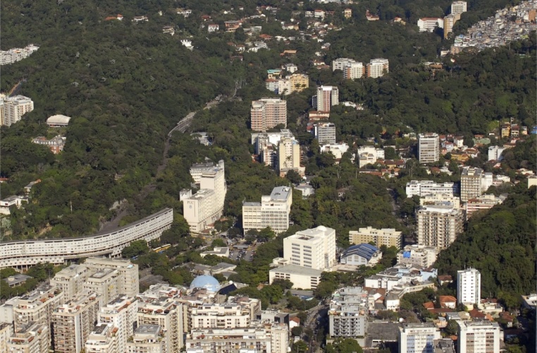 Vista aérea da PUC-Rio. Estão visíveis o Túnel Acústico da Auto-Estrada Lagoa-Barra, o Conjunto Habitacional Marquês de São Vicente (Minhocão), o Planetário da Gávea, o Instituto Gênesis, o prédio do Núcleo Regional de Competência em Petróleo e Gás, o Edifício Garagem e o Espaço Cultural e Esportivo Padre Ormindo Sodré Viveiros de Castro S.J.. 2010. Fotógrafo Nilo Lima. Acervo do Núcleo de Memória.