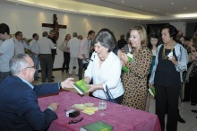 O Reitor Prof. Pe. Josafá S.J. autografa o seu livro para a Profa. Angeluccia Habert (COM). Fotógrafo Antônio Albuquerque. Acervo do Núcleo de Memória.