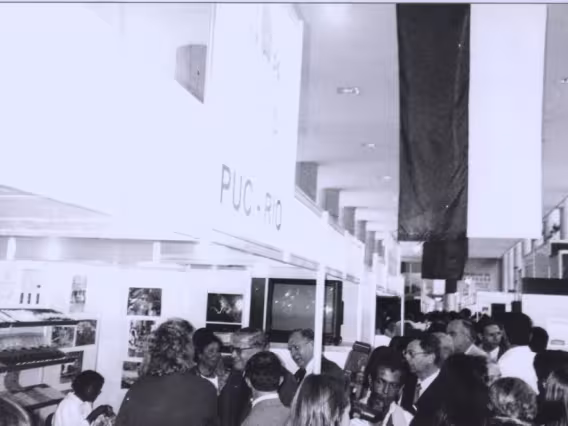 O Reitor Pe. Hortal S.J. visita os standes nos pilotis do Ed. da Amizade. Fotógrafo Jorge Paulo. Acervo Comunicar.